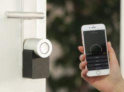 Types of Door Locks: A person unlocks a smartlock with a phone app