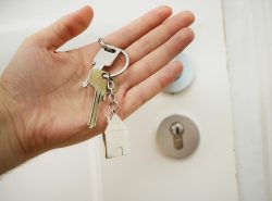 Commercial locksmith services explained - an image of a person holding keys